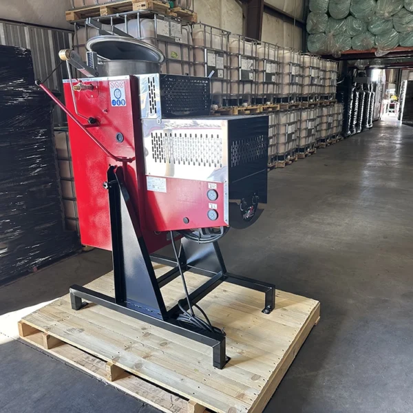 Angled side view of the Formeco Distiller DI 60 showing the control panel and part of the red housing, positioned on a wooden pallet.